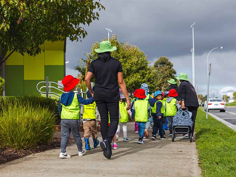 Y Early Learning educators take a group of children out walking in the community
