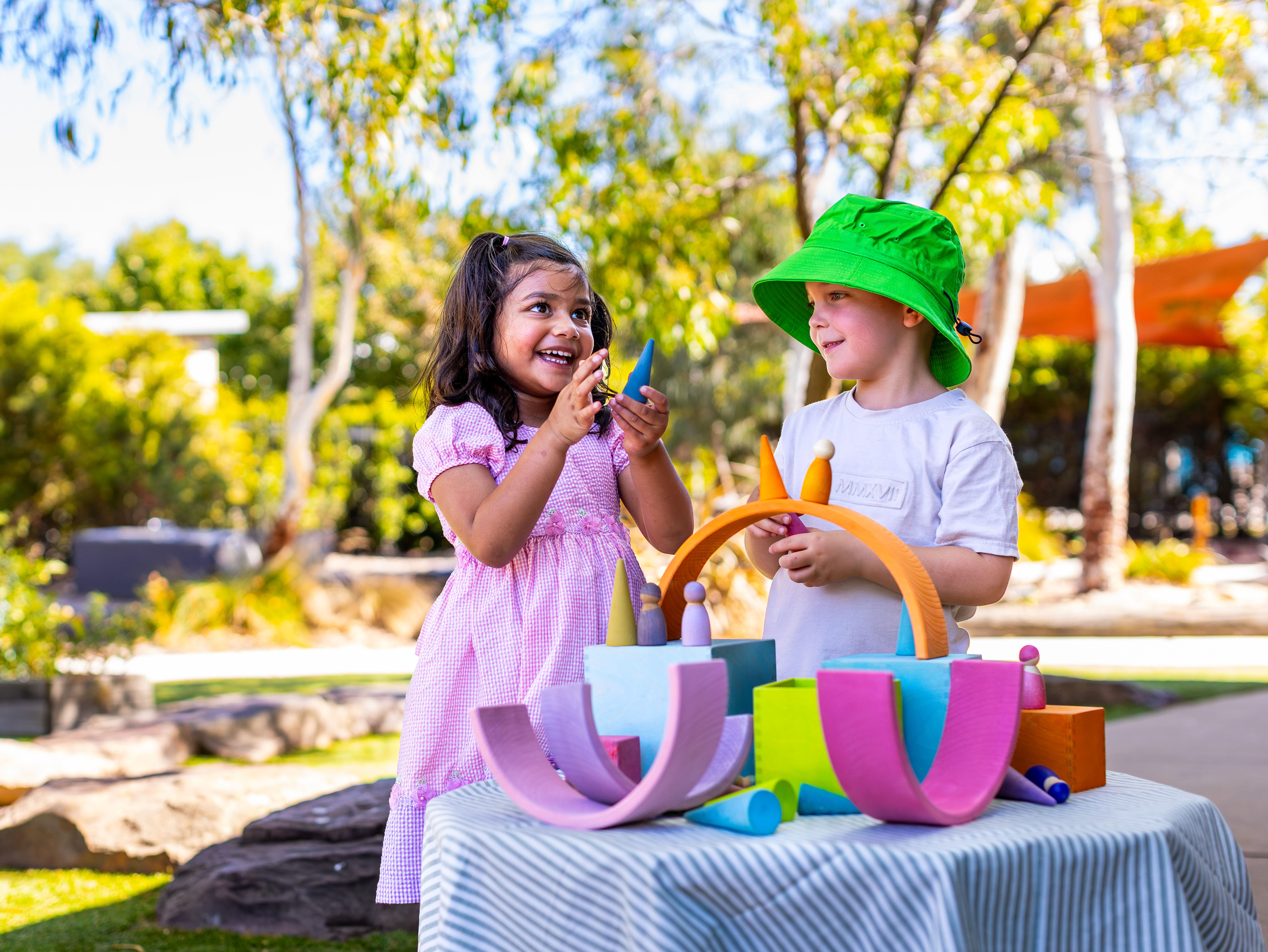A girl and boy playing together outdoors